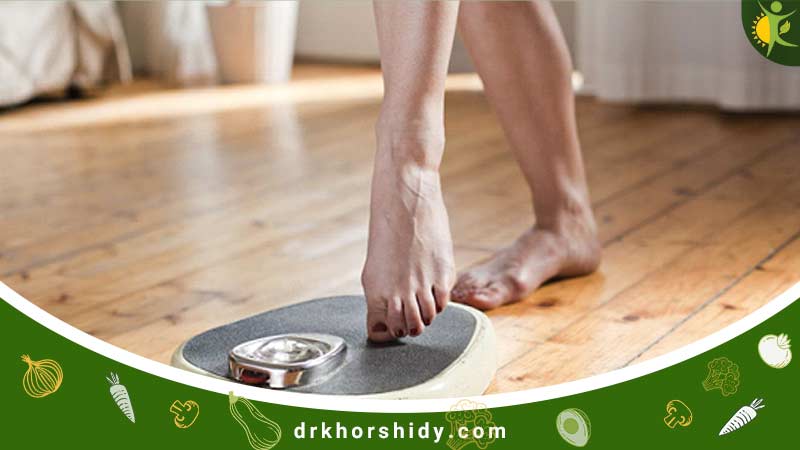 خانمی در حال وزن کردن خودش